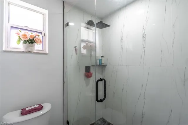 a bedroom with a bed and a chair