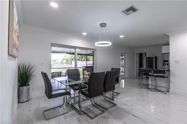 a living room with furniture and potted plant