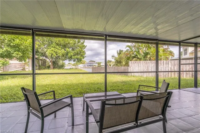 a view of a porch with chairs and backyard
