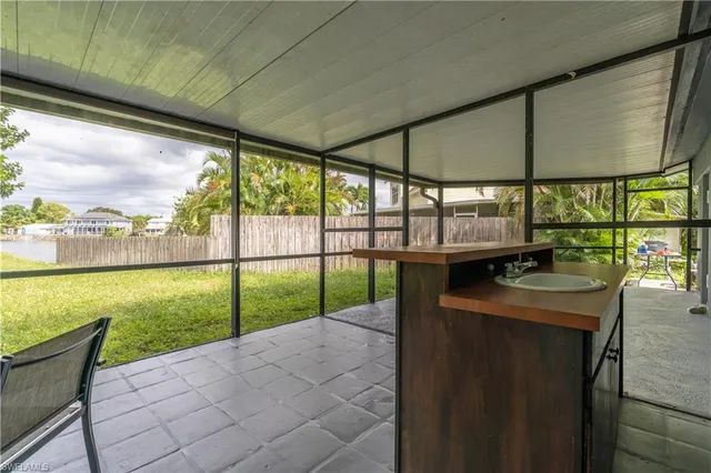 a view of an empty room with a floor to ceiling windows and a table