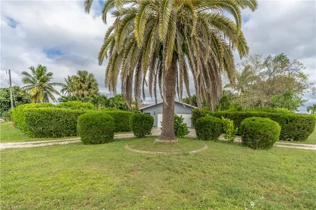 a backyard of a house with table and chairs