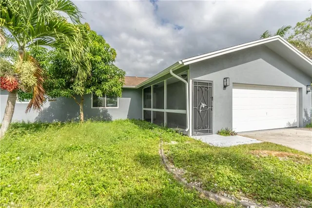 an aerial view of a house with a yard and lake view