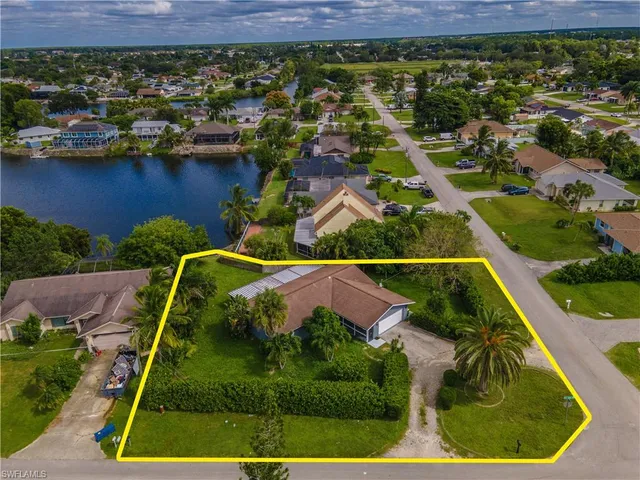 an aerial view of a house with a lake view