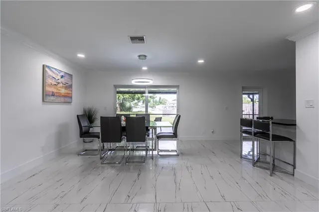 a view of a dining room with furniture and a window