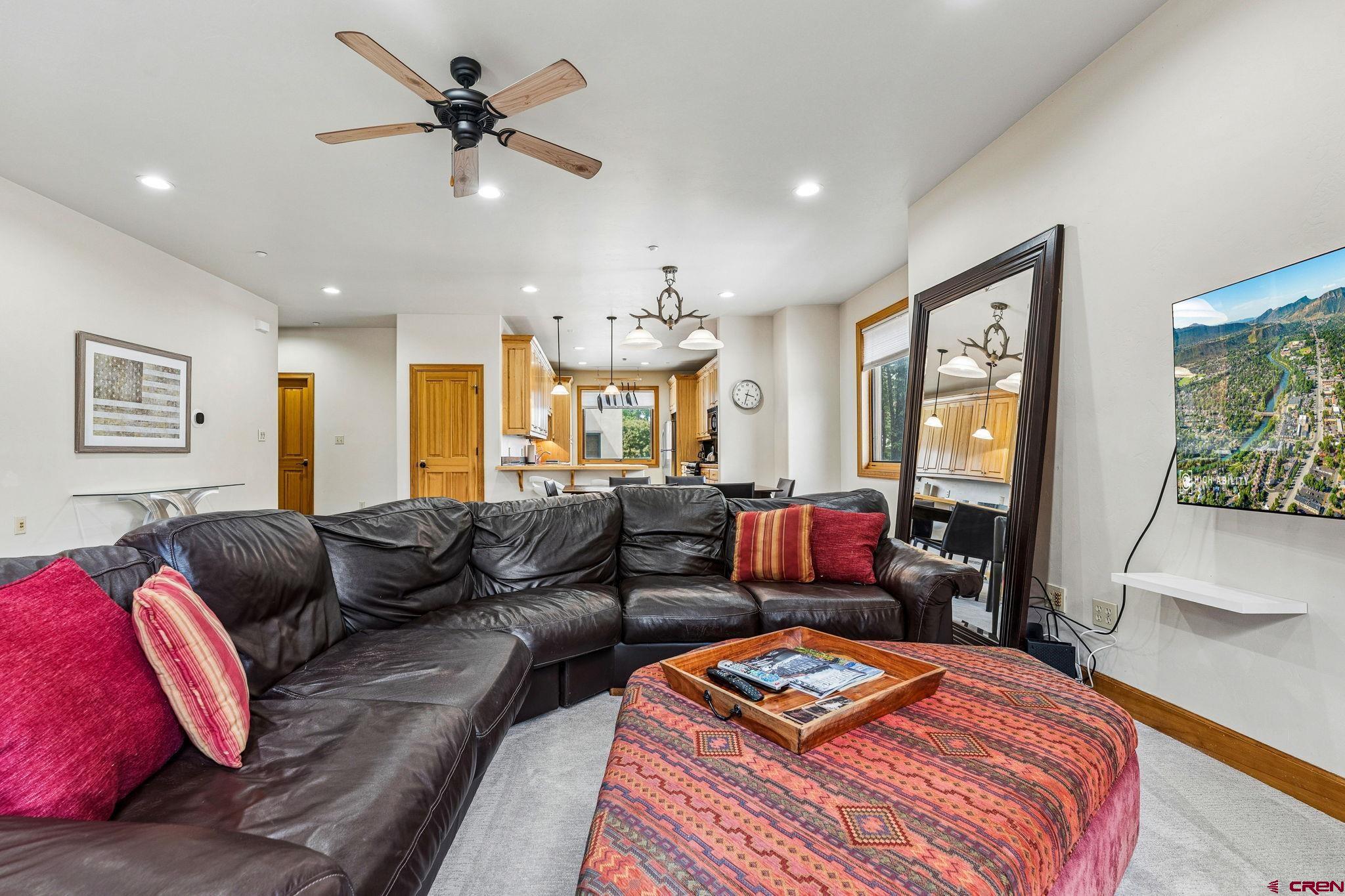 1422 Animas View Drive, Unit 55 Durango, CO 81301 - Photo 7 of 44 a living room with furniture ceiling fan and a rug