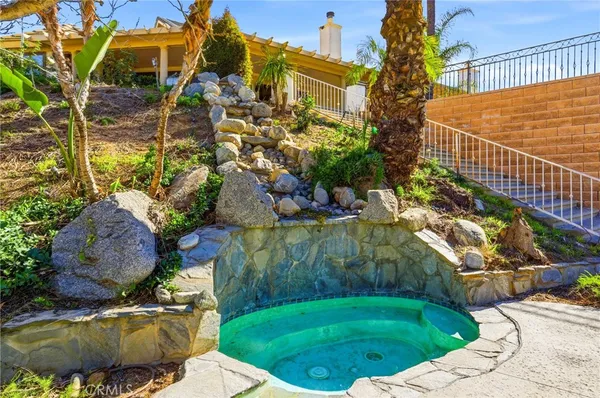 a swimming pool with outdoor seating and yard