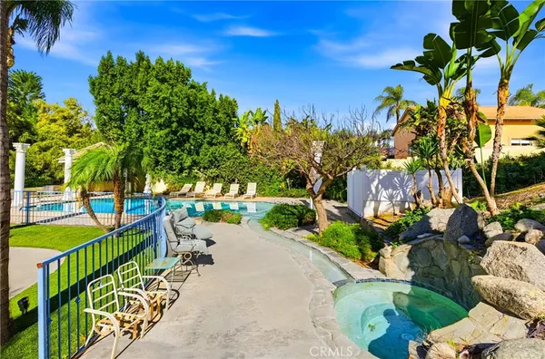 a view of a house with backyard and sitting area