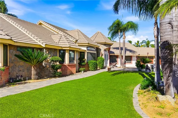 a view of a house with a backyard porch and sitting area