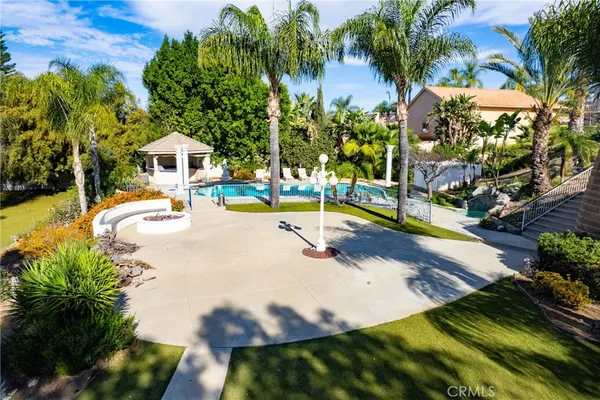 a swimming pool with some trees in the background