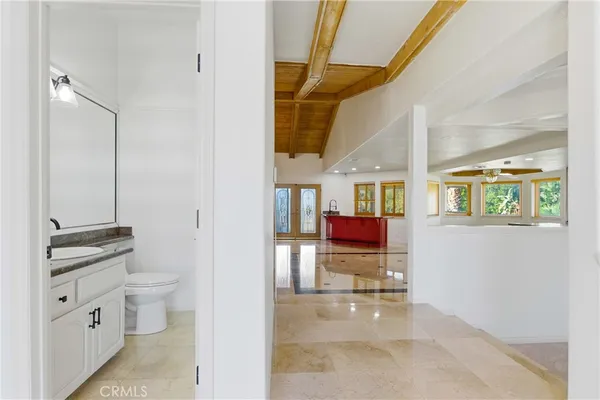 a view of a hallway with dining area window and wooden floor