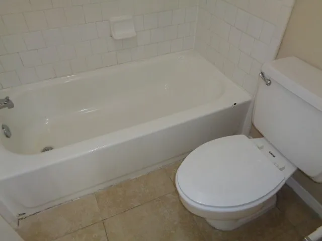 a bathroom with a sink a toilet and bathtub