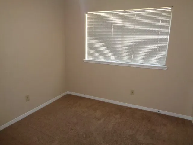 a view of a small house with backyard