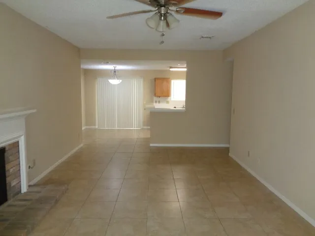 a view of an empty room with a fireplace