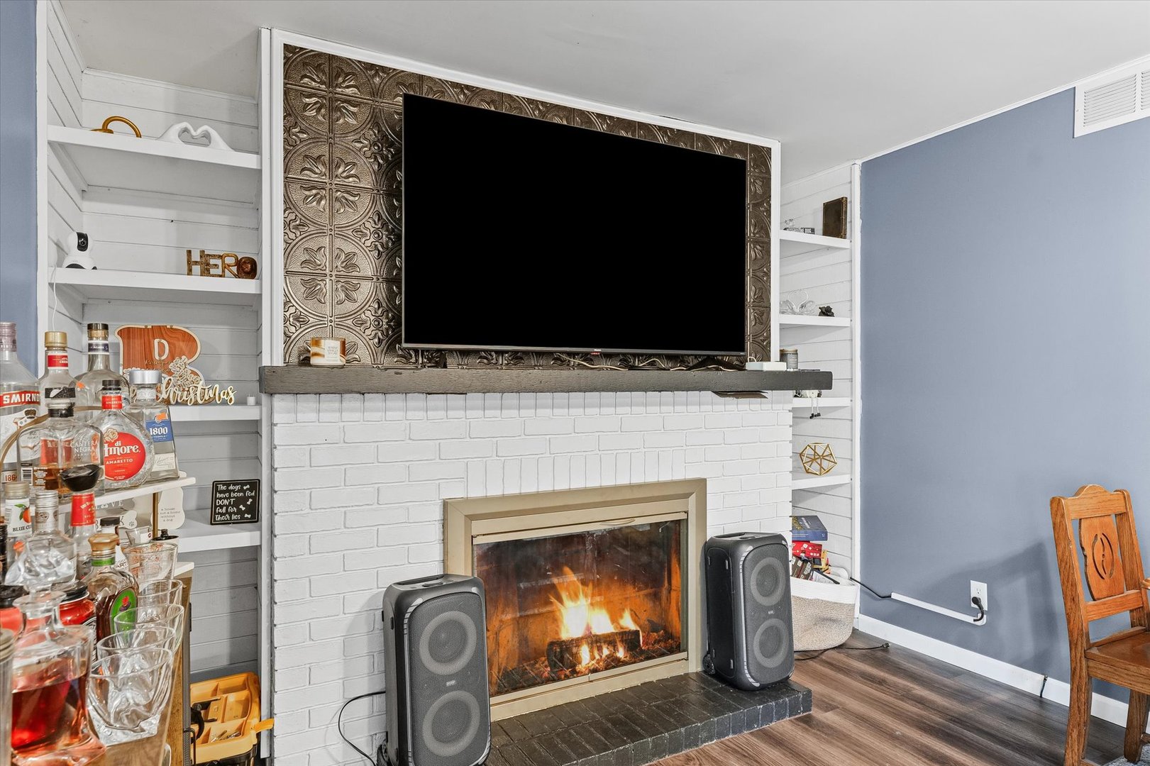 1715 Phillippe Drive Mahomet, IL 61853 - Photo 14 of 30 a living room with a fireplace and a flat screen tv