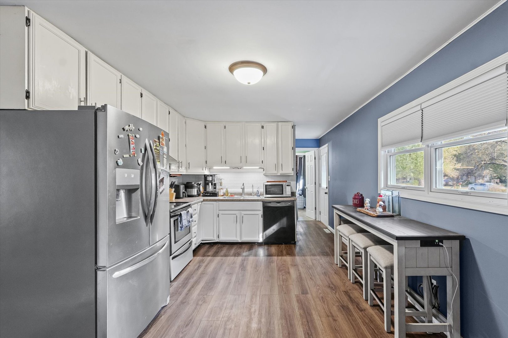 1715 Phillippe Drive Mahomet, IL 61853 - Photo 7 of 30 a kitchen with cabinets and stainless steel appliances