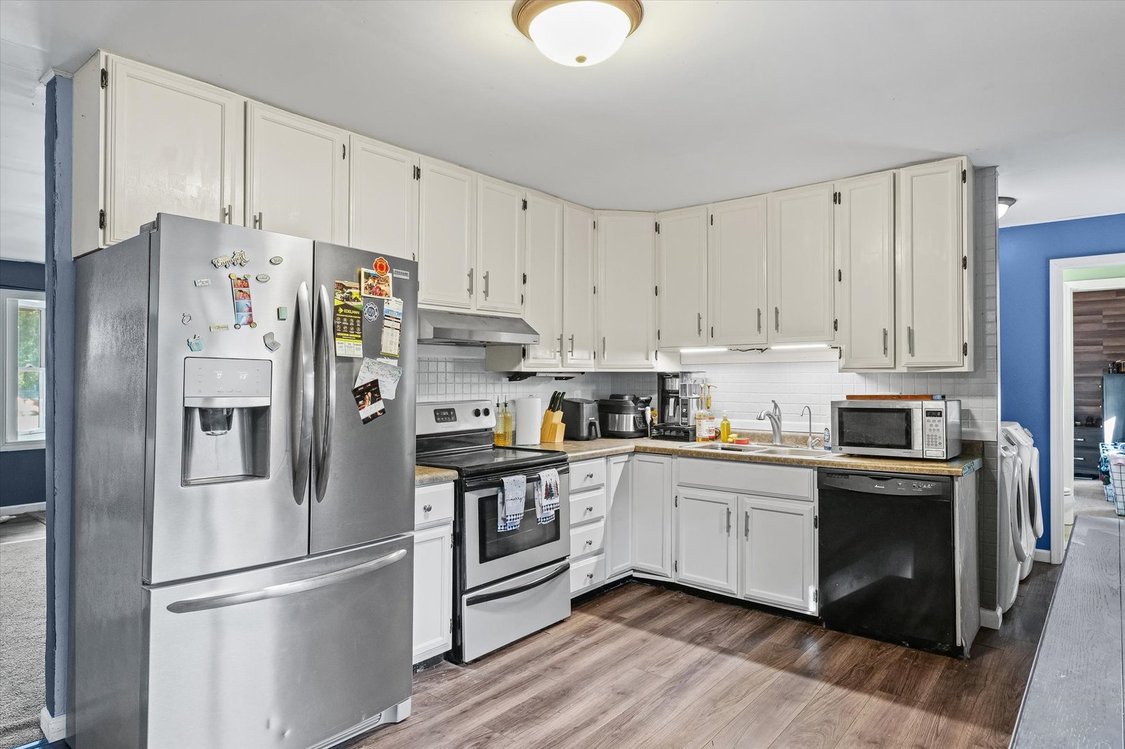 1715 Phillippe Drive Mahomet, IL 61853 - Photo 8 of 30 a kitchen with stainless steel appliances granite countertop a refrigerator sink and cabinets