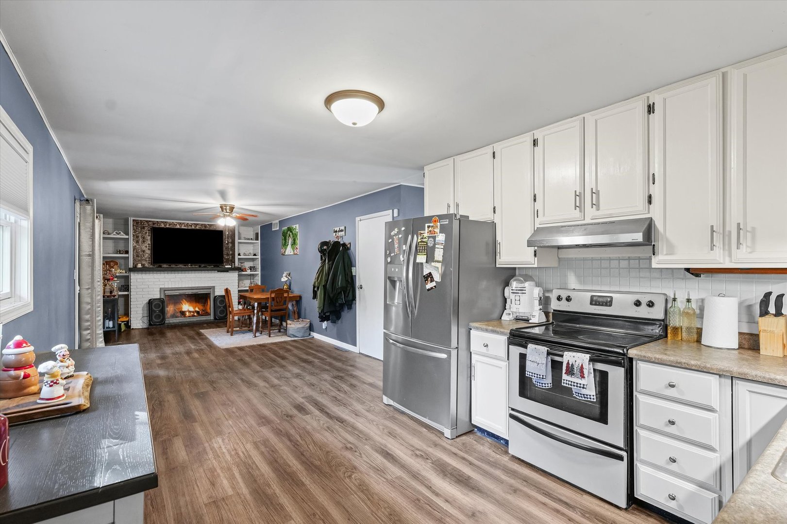 1715 Phillippe Drive Mahomet, IL 61853 - Photo 9 of 30 a kitchen with stainless steel appliances a stove refrigerator sink and cabinets