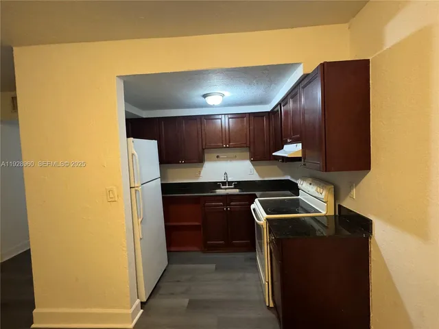 a kitchen with a sink and a refrigerator