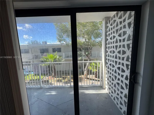 a view of a glass door with a balcony