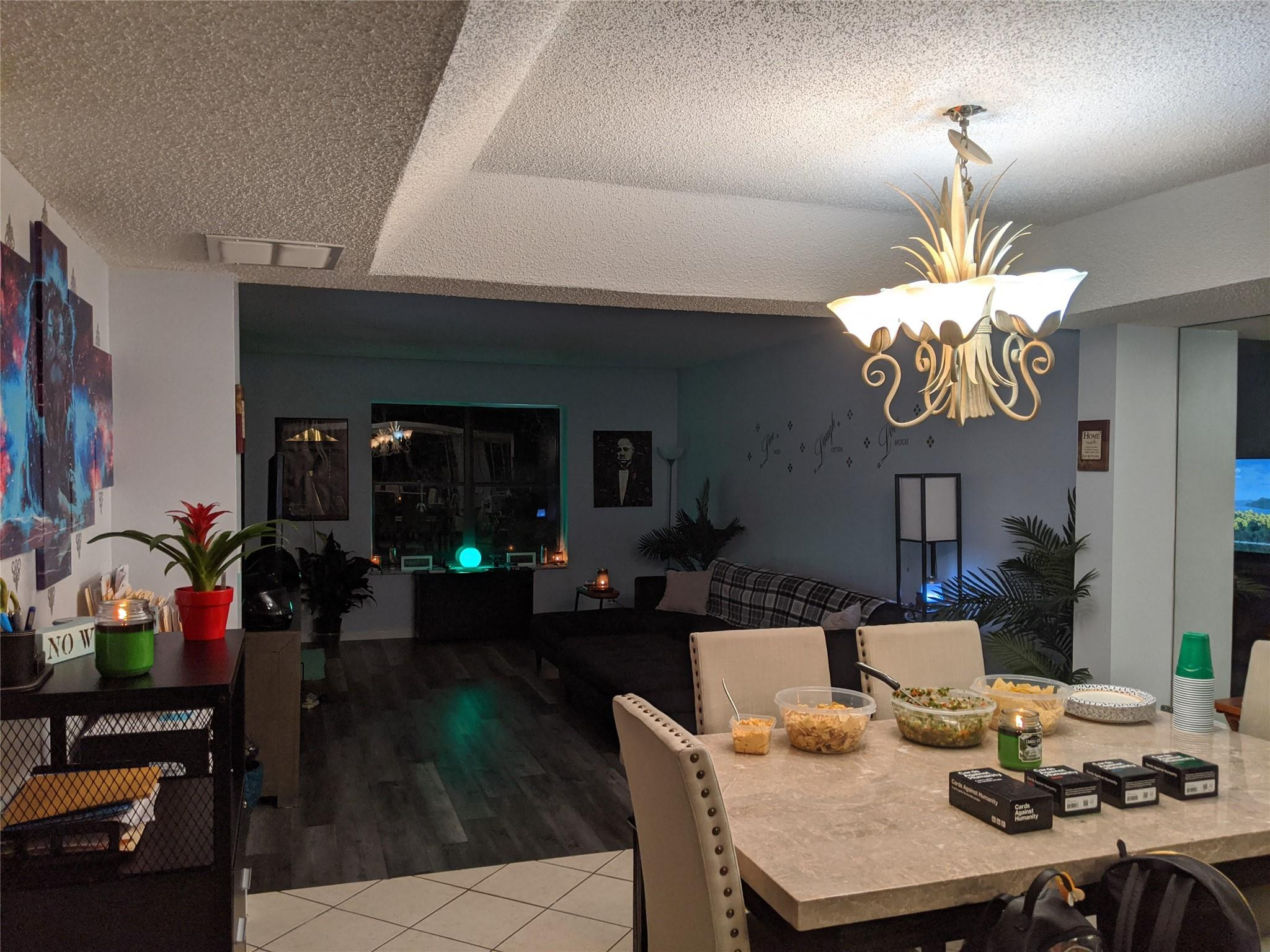 3760 Inverrary Drive, Unit 3L Lauderhill, FL 33319 - Photo 3 of 10 a living room with dining table furniture and a chandelier
