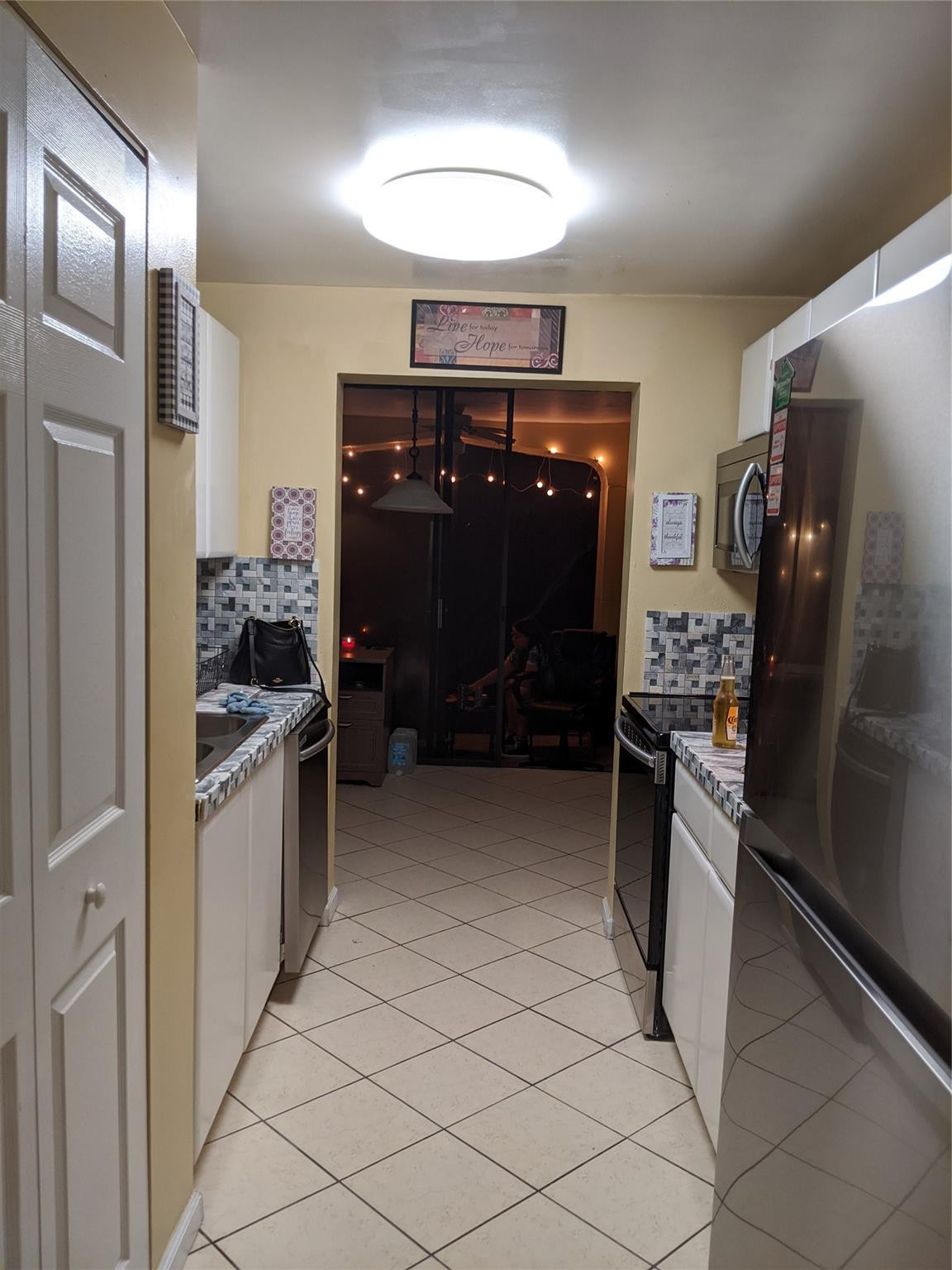 3760 Inverrary Drive, Unit 3L Lauderhill, FL 33319 - Photo 5 of 10 a kitchen with a refrigerator and a sink