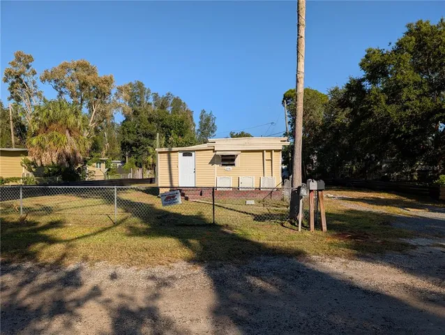 a view of a house with swimming pool next to a yard