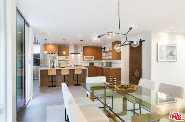 a large kitchen with a table and chairs