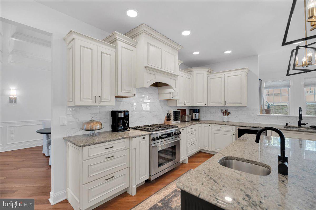 425 Peltoma Road Haddonfield, NJ 08033 - Photo 7 of 33 a kitchen with granite countertop white cabinets stainless steel appliances and sink