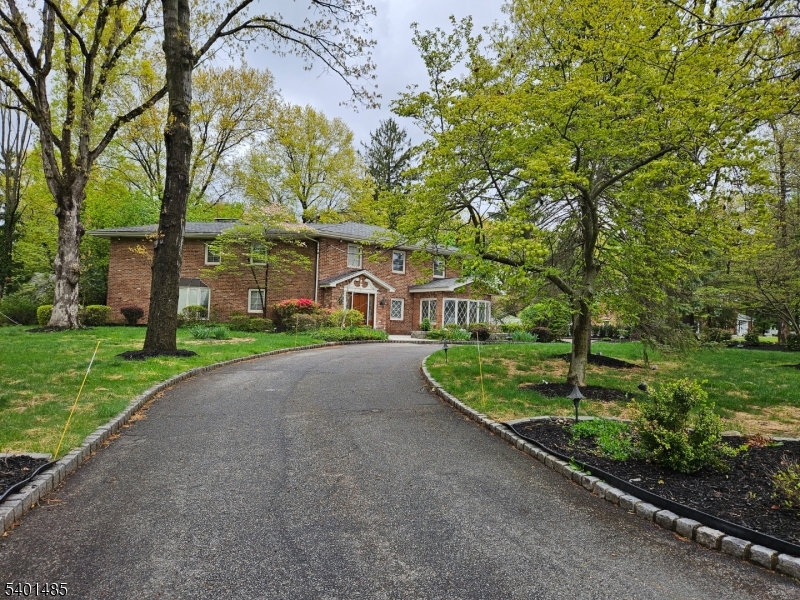 218 Devon Road Essex Fells, NJ 07021 - Photo 20 of 23 a view of a house with a yard and large trees
