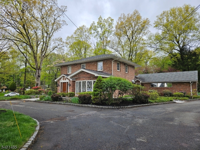 218 Devon Road Essex Fells, NJ 07021 - Photo 22 of 23 a front view of a house with a garden