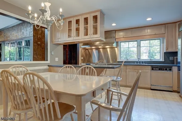 a dining table with chairs and chandelier