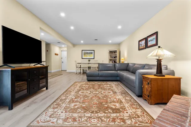 a dining room with furniture and wooden floor