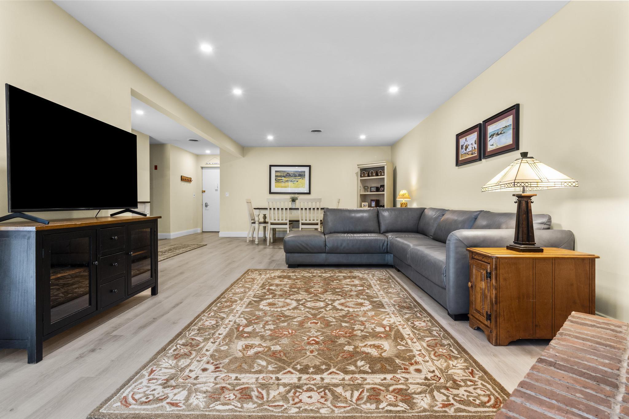 28 Mill Hill Road, Unit 28 Fairfield, CT 06890 - Photo 12 of 37 a living room with furniture and a flat screen tv