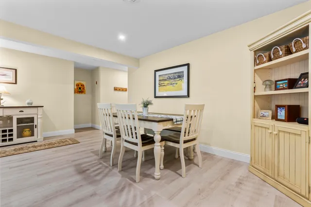 a dining room with furniture and wooden floor