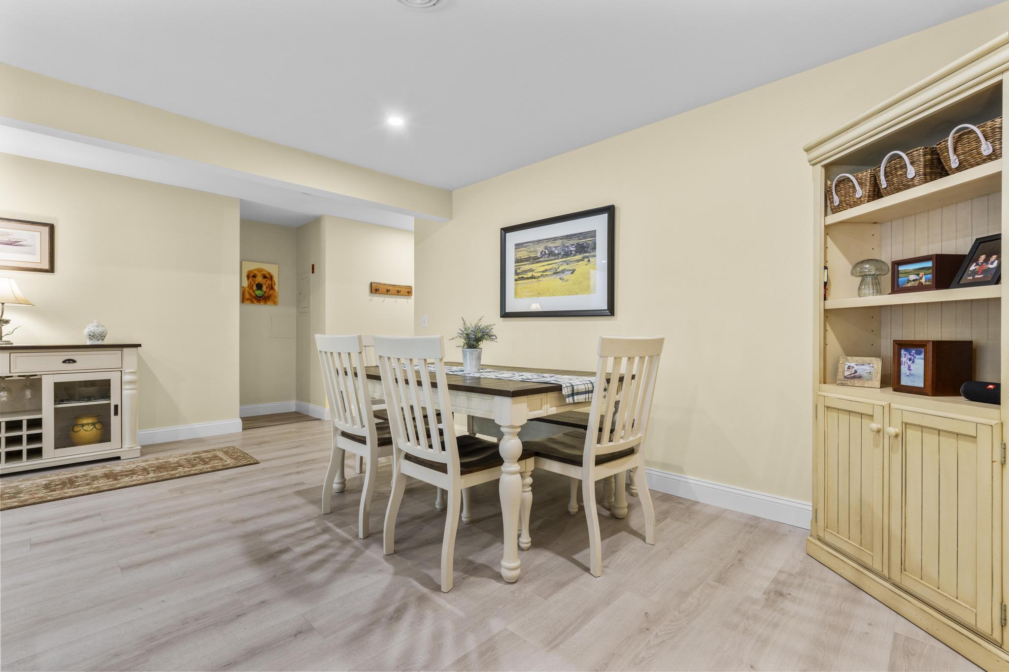 28 Mill Hill Road, Unit 28 Fairfield, CT 06890 - Photo 13 of 37 a dining room with furniture and wooden floor