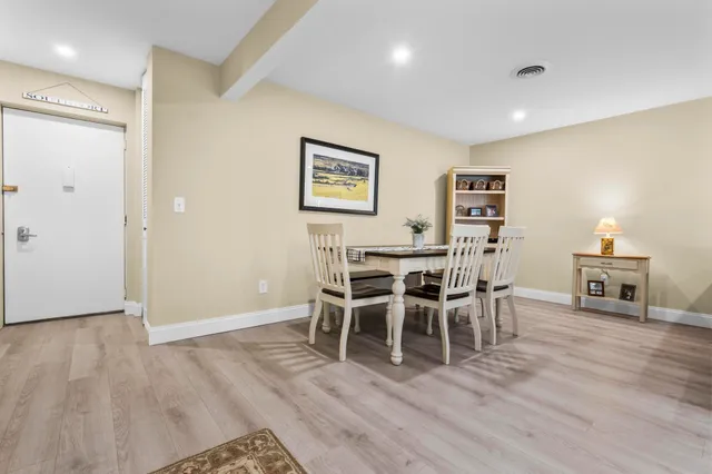 a kitchen with a refrigerator and a stove top oven