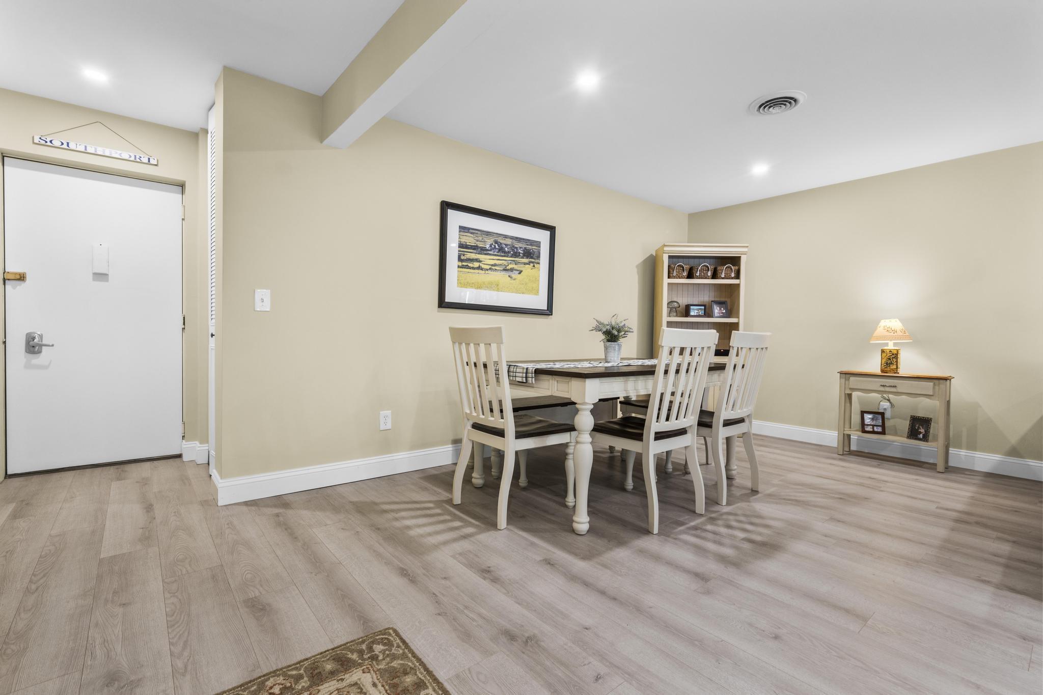 28 Mill Hill Road, Unit 28 Fairfield, CT 06890 - Photo 14 of 37 a dining room with furniture and wooden floor