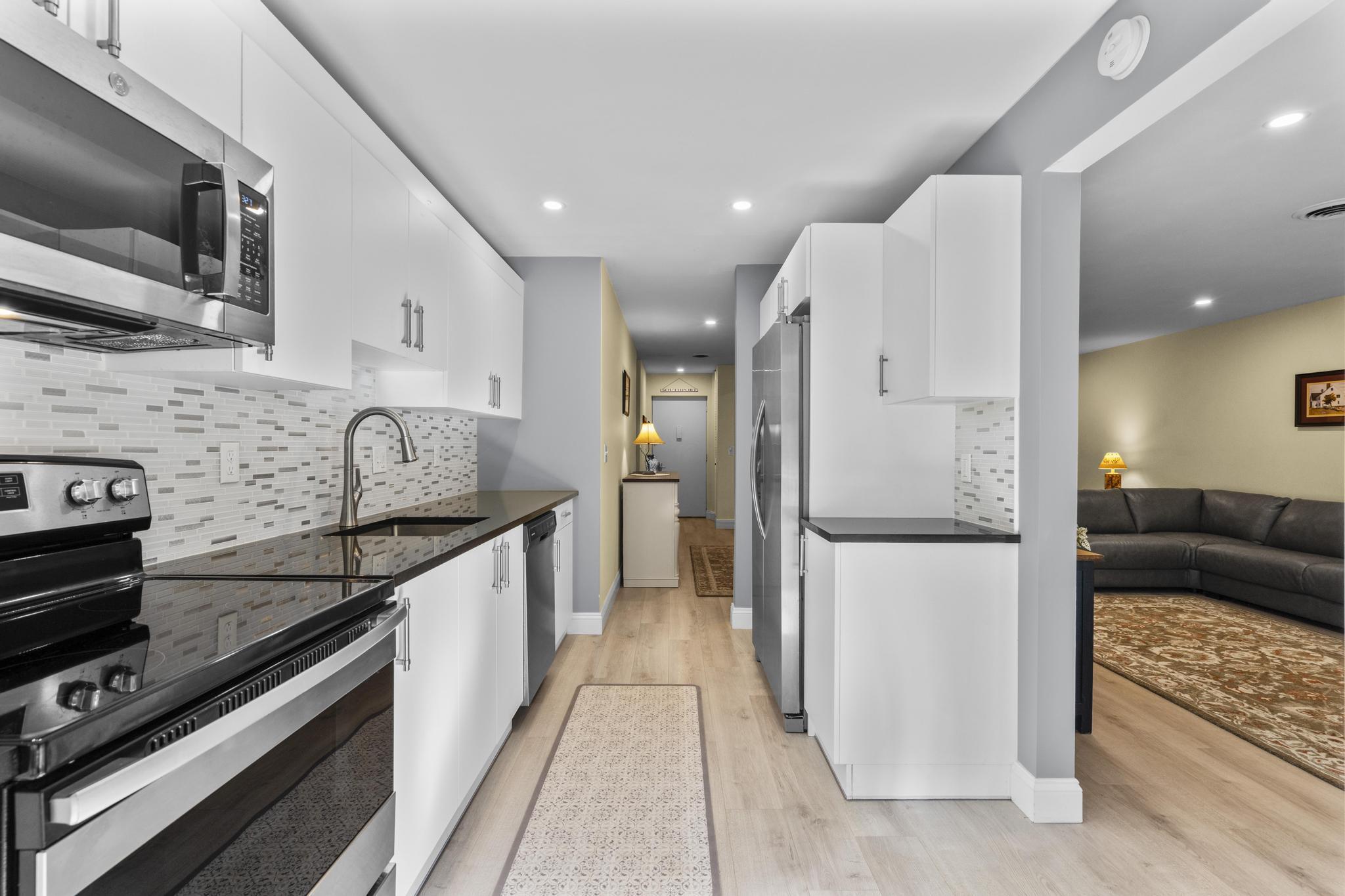 28 Mill Hill Road, Unit 28 Fairfield, CT 06890 - Photo 15 of 37 a kitchen with a refrigerator and a stove top oven
