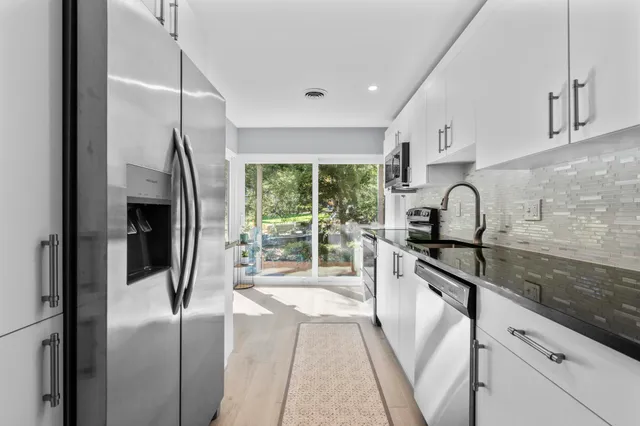 a kitchen with a refrigerator and a sink