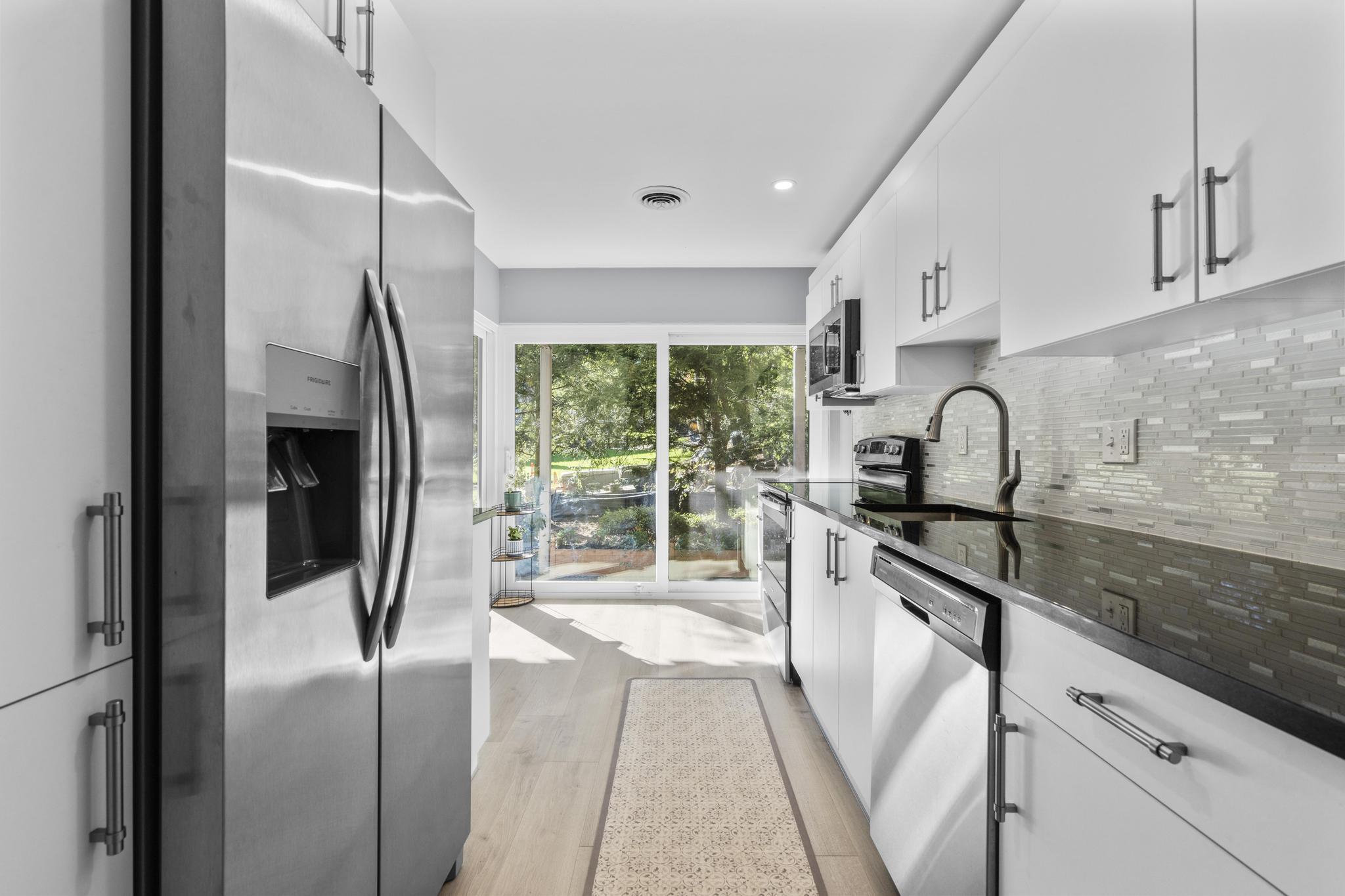 28 Mill Hill Road, Unit 28 Fairfield, CT 06890 - Photo 17 of 37 a kitchen with stainless steel appliances granite countertop a refrigerator and a sink
