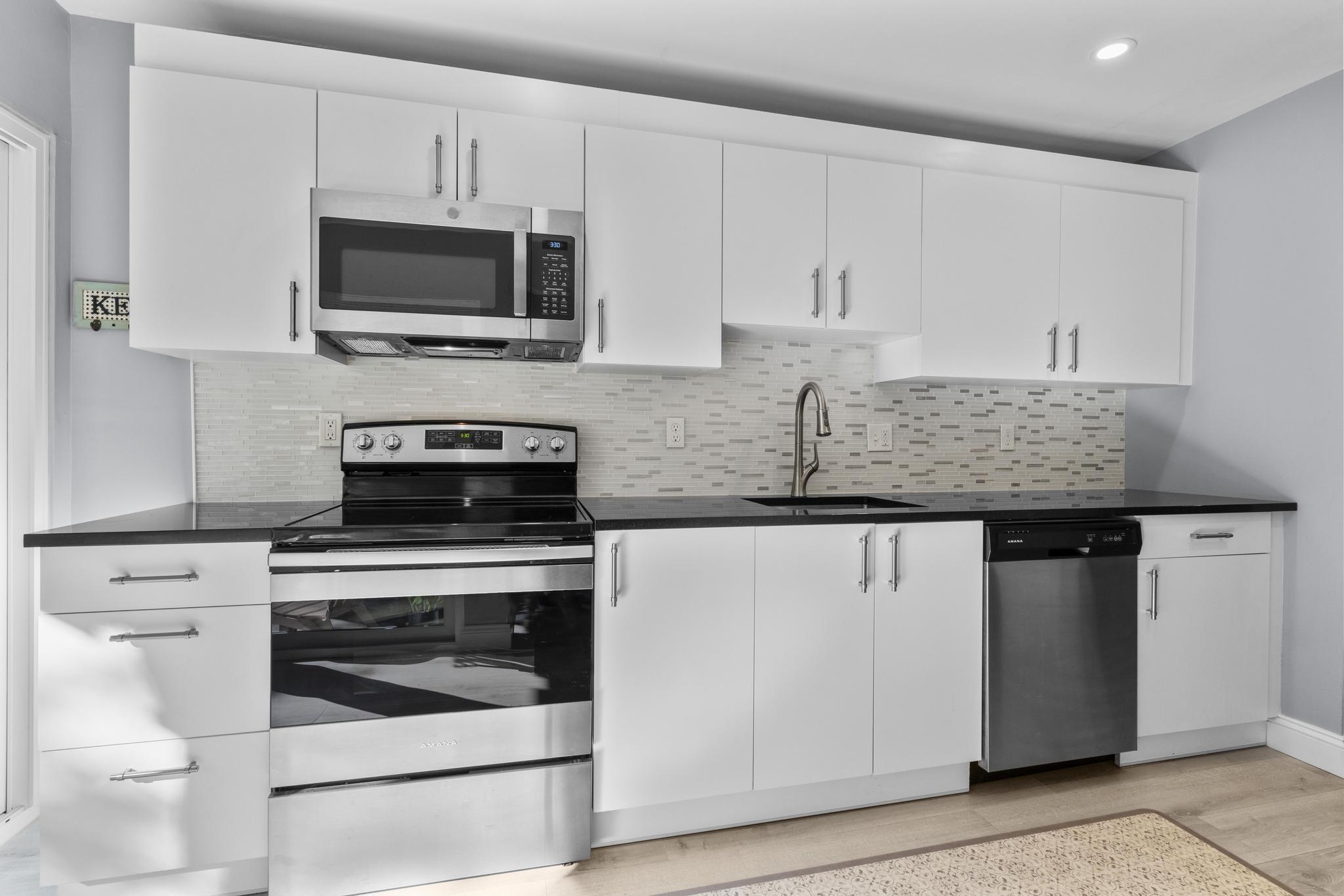 28 Mill Hill Road, Unit 28 Fairfield, CT 06890 - Photo 19 of 37 a kitchen with appliances a sink and cabinets