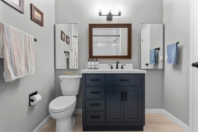 a bathroom with a sink toilet and shower