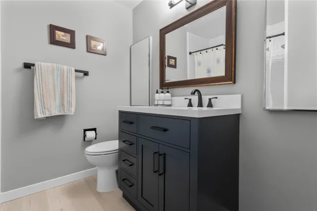 a bedroom with a bed a mirror and a window