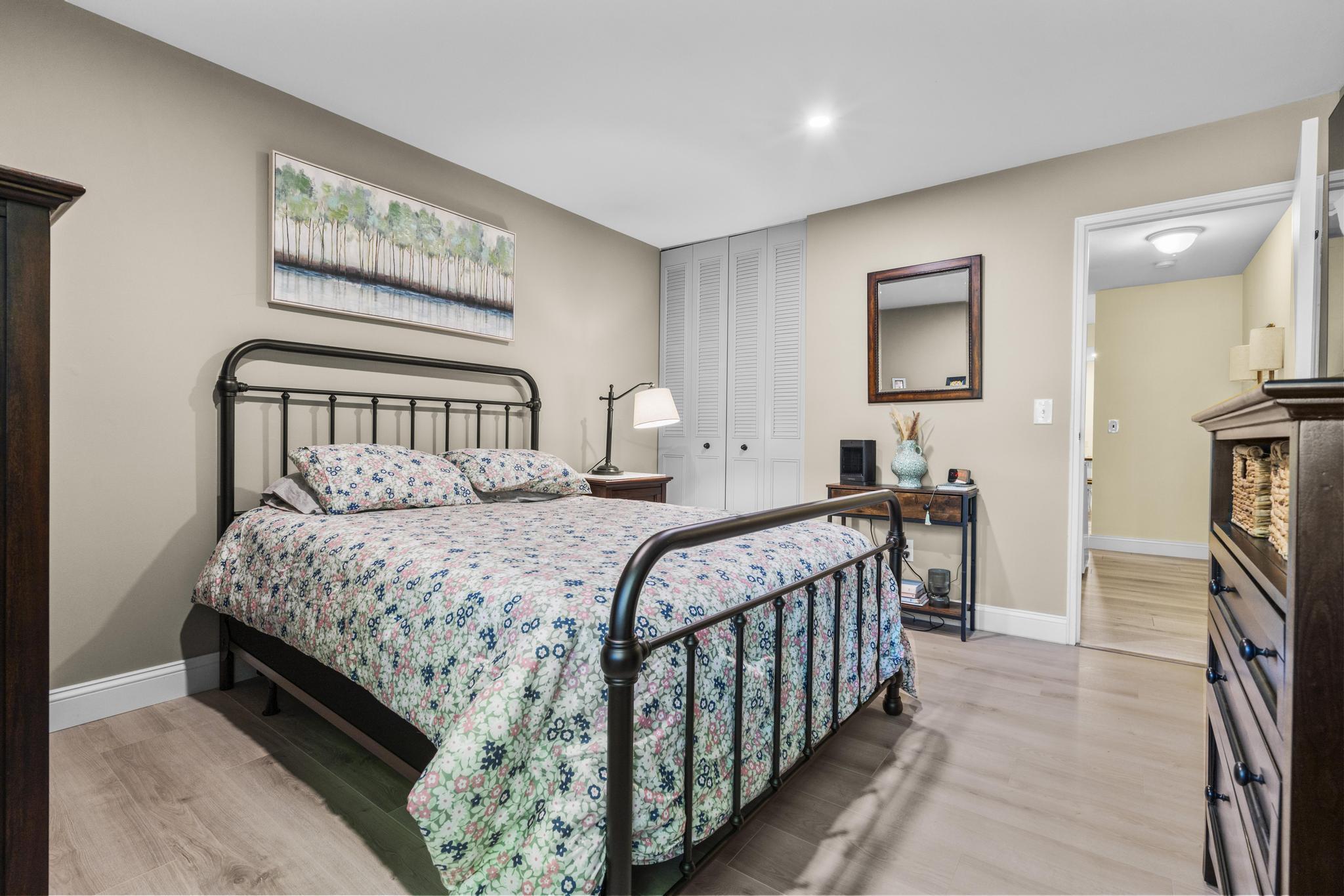 28 Mill Hill Road, Unit 28 Fairfield, CT 06890 - Photo 30 of 37 a bedroom with a bed a mirror and a window