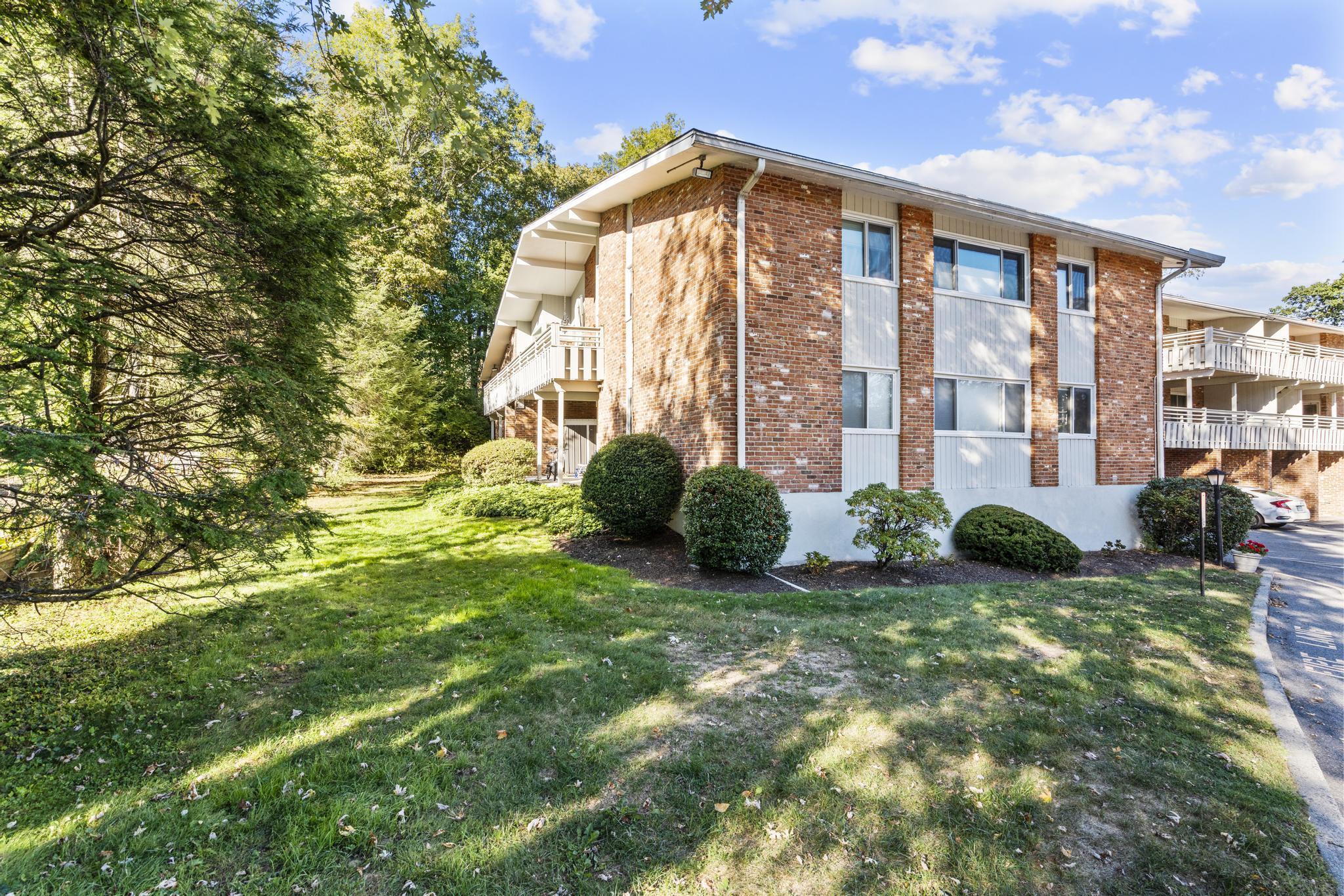 28 Mill Hill Road, Unit 28 Fairfield, CT 06890 - Photo 35 of 37 a front view of a house with a yard