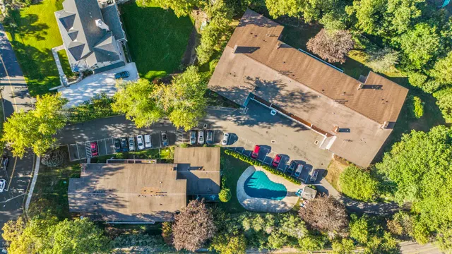 an aerial view of a house with a yard and swimming pool