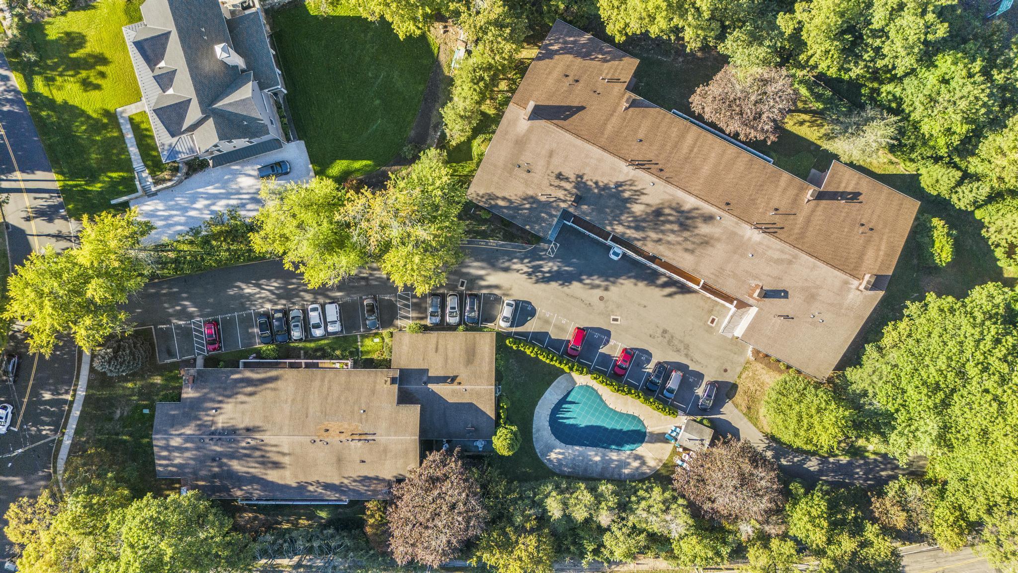 28 Mill Hill Road, Unit 28 Fairfield, CT 06890 - Photo 5 of 37 an aerial view of a house with a yard and swimming pool