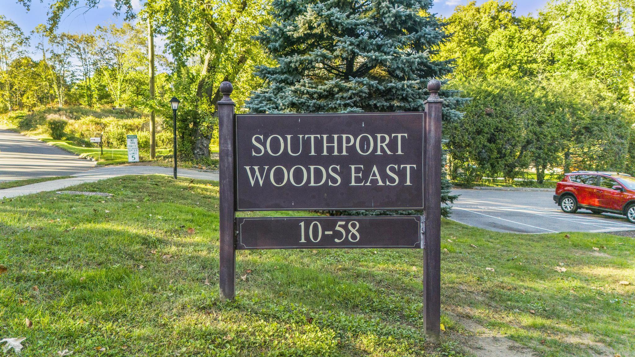 28 Mill Hill Road, Unit 28 Fairfield, CT 06890 - Photo 9 of 37 a sign of golf club on a wall under a tree