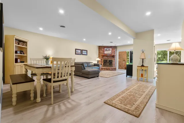 a living room with furniture large window and a fireplace