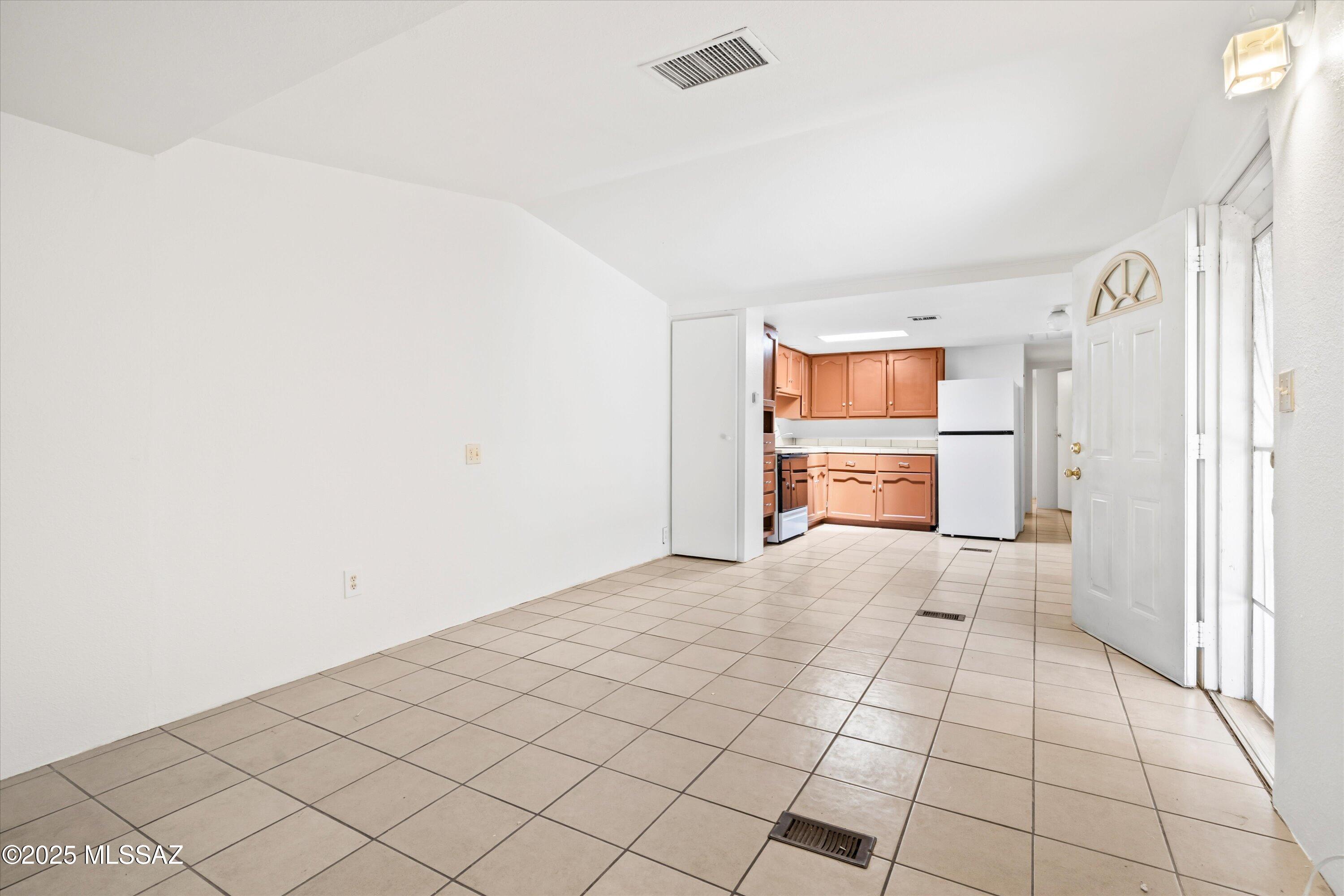 1227 East Ginter Road Tucson, AZ 85706 - Photo 12 of 18 a view of empty room with wooden floor and cabinet